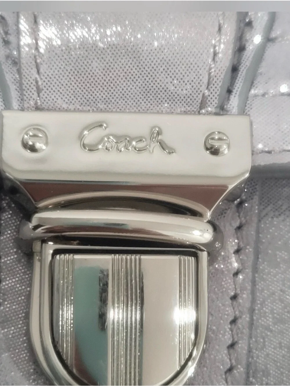 Coach Poppy Layla shimmery leather shoulder bag with a push-lock closure.
